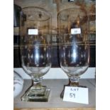 A pair of modern glass storm lanterns with engraved star motifs,