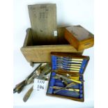 An oak lidded box containing a small quantity of plated flatware to include fish cutlery,