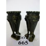 A pair of metal vases in the Empire style est;