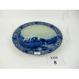 A large Delft blue and white charger painted with cattle in a landscape signed 'J Vrolijk' in a