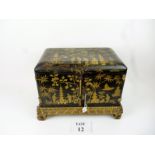 A 19th century Chinese export black lacquer cabinet decorated with figures, pagodas,