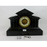 A Victorian black slate mantle clock of