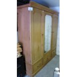 A Victorian pine triple wardrobe with ce