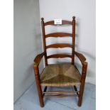 A 19c oak ladder back elbow chair with r