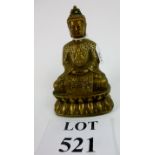 An Oriental bronze Buddha seated on a lo