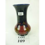 A William Moorcroft Pomegranate pattern cobalt trumpet shaped vase No 57,