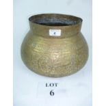 An Indian brass pot engraved with animal