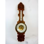 A well carved oak barometer with thermom