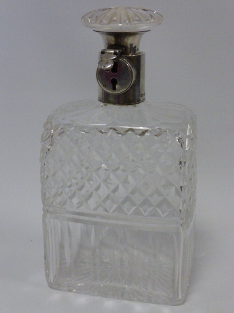 A silver-mounted lockable decanter, hallmarked Birmingham 1928, by Hukin and Heath,