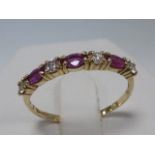 9ct gold Ruby and white stone set eternity ring, size S/T.