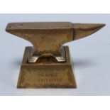 Trench Art - in the form of a Blacksmiths anvil marked "EDNA" & "JIM" on decorated base marked