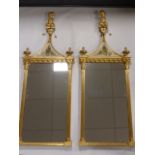 A pair of giltwood and verre eglomise Regency style pier mirrors, 20th Century,
