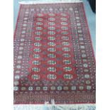 Iranian rug with three rows of twelve guls, 173x124cms.