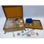 A 'Reuge' musical leather jewellery box containing vintage brooches and other jewellery including