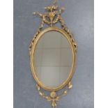 A George III oval giltwood frame with later mirror plate,