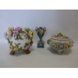 Continental porcelain vase with applied roses, raised on three stem feet,