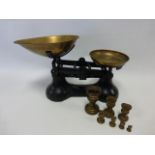 Kitchen scales with brass pans and weights.