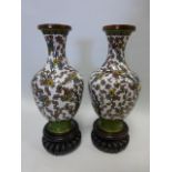 Pair of cloisonne enamel vases with foliate decoration, with stands, 24cm total height,