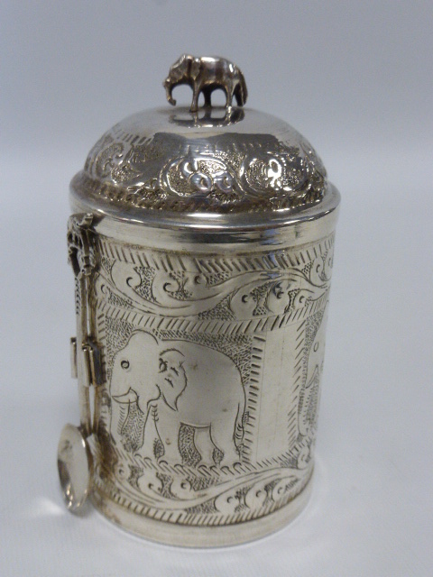 Indian silver lidded caddy with attached spoon engraved with panels of elephants,