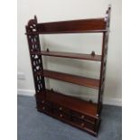 Mahogany wall shelf unit with fretwork sides to three shelves above six small drawers, 77x18.5x111.