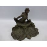 Cast bronze woman in flowing dress standing behind two water lilies, indistinct signature to side,