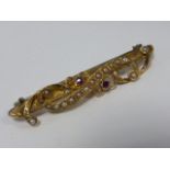 Victorian 15ct gold bar brooch set with rubies and seed pearls, 4.2cms in length.