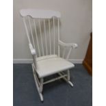 Contemporary white painted wooden rocking chair with spindle back.