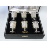 Cased set of six Sterling silver goblets, with embossed floral and foliate decoration,