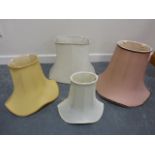 Four lamp shades of various sizes.
