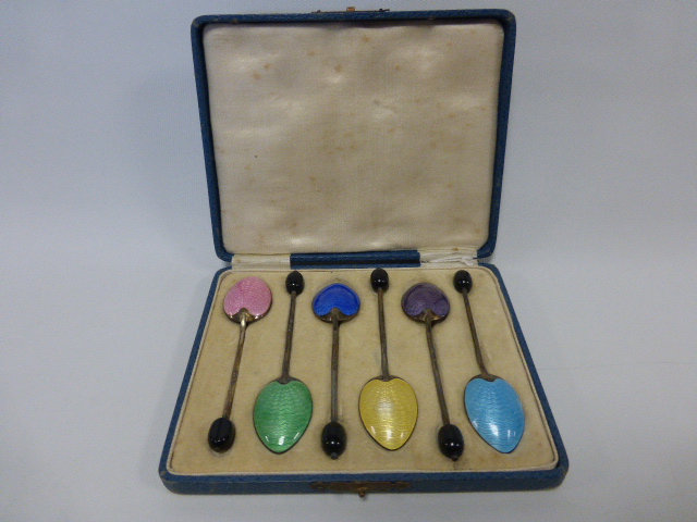 An Art Deco cased set of six silver and guilloche enamel coffee bean teaspoons,