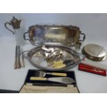 Two large silver plated twin handled trays, a set of six large plated coasters, claret jug,