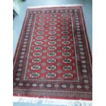 Iranian rug with three rows of twelve guls, 184x125cms.