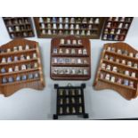 Collection of 230 assorted china, metal and glass thimbles on seven wall mounted display shelves.