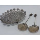 Filigree white metal dish together with a pair of filigree white metal spoons,