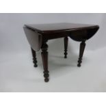 Mahogany Apprentice piece oval drop leaf table on turned reeded supports, 23.