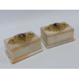 Pair of French onyx boxes with ornate gilt hinges and banded agate cabochon to top,