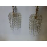 A pair of gilt and crystal light fittings