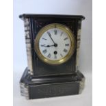 A 19th Century slate and marble mantle clock with white enamel dial and Roman numerals,