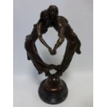 Cast Bronze of a couple dancing cheek to cheek on domed base and circular marble plinth, 42cm high.