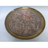 A brass tazza with copper relief scene of a returning Athena into Rome30.25cms in diameter.