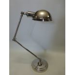 Nickel plated desk top angle poise lamp on circular base, approx 70cm high.