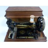 Vintage Singer sewing machine with wooden case, Serial No. J1537711.