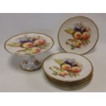 Continental porcelain tazza and six plates with peaches and plums decoration and gilded borders,