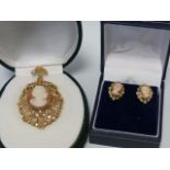 A large 9ct gold Cameo pendant and associated earrings, one butterfly back missing.