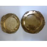 Two Chinese brass trays with grape and vine borders and engraved figural centres,