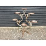 Victorian cast iron plant pot display stand of scrolled symmetrical form on four supports & six pot
