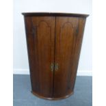 Georgian bow front corner wall cupboard with twin inlaid doors and three internal shelves,