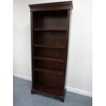 Tall mahogany veneered bookcase with moulded dentil cornice and four adjustable shelves,