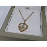 9ct gold filigree pearl set heart shaped pendant on a 9ct gold 18" chain.