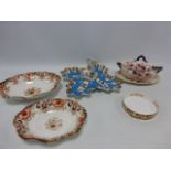 A quatrefoil ceramic dish with panels decorated with flowers and central stylized Dolphin handle,